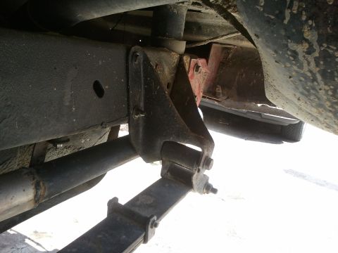 1978 Ford Bronco - Underside view of a vehicle's frame, showing suspension parts and exhaust pipe.