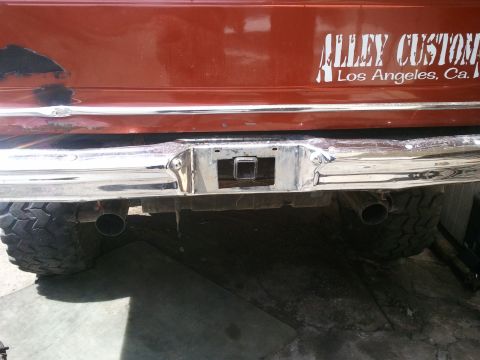 1978 Ford Bronco - Rear view of a vehicle dual exhaust pipes, a trailer hitch receiver, and a custom decal reading "Alley Custom Los Angeles, Ca."