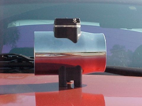 1995 Ford Mustang - A chrome mass air flow sensor housing is shown resting on the hood of a red vehicle.