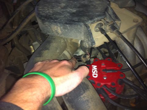1990 Ford Bronco - MSD ignition distributor is visible in the engine bay, with a hand pointing to a wire connector.