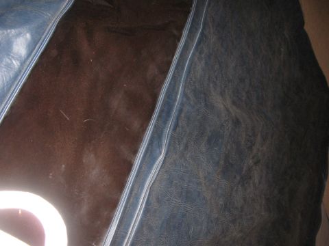 1990 Ford Bronco - The image shows a close-up view of the interior upholstery, dark brown and blue vinyl sections.
