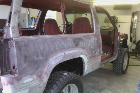 1994 Chevrolet Blazer - This maroon 1994 Chevrolet Blazer is in a workshop, undergoing significant bodywork and repairs.