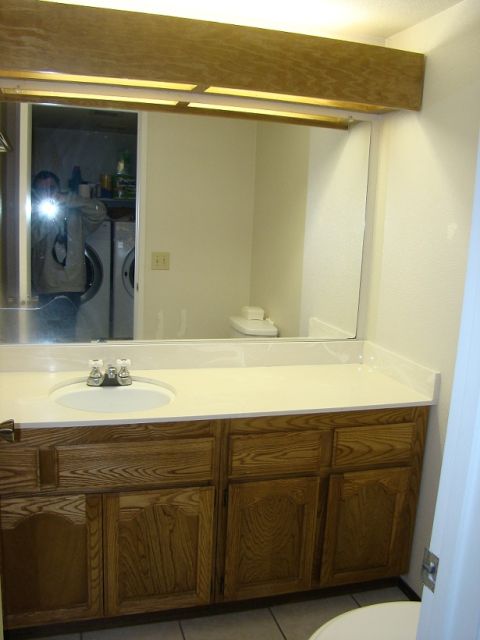 1989 Ford Bronco - A bathroom vanity with a sink and mirror is shown, reflecting laundry machines in the background.