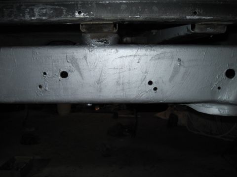 1979 Ford Bronco - Close-up view of a vehicle's painted frame, showing structural components and mounting points.