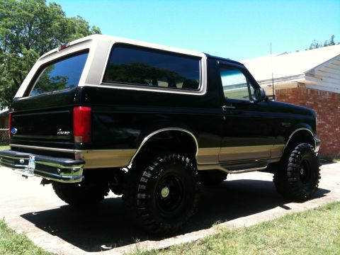 1996 Ford Bronco - This lifted 1996 Ford Bronco has a two-tone black and tan paint scheme and aggressive off-road tires.