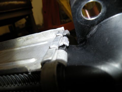 2006 Subaru Legacy - Detail of an intercooler mounting bracket, showing the connection points and metal fins of the intercooler.