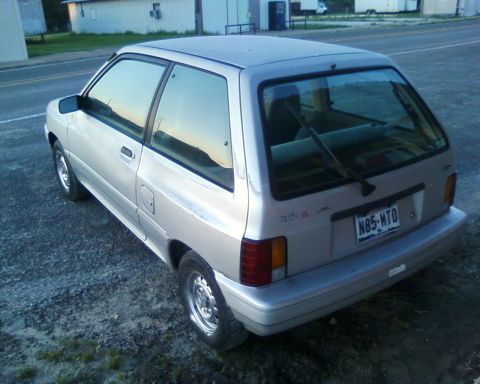 1991 Ford Festiva - This silver 1991 Ford Festiva is shown from the rear three-quarter angle, displaying its license plate.