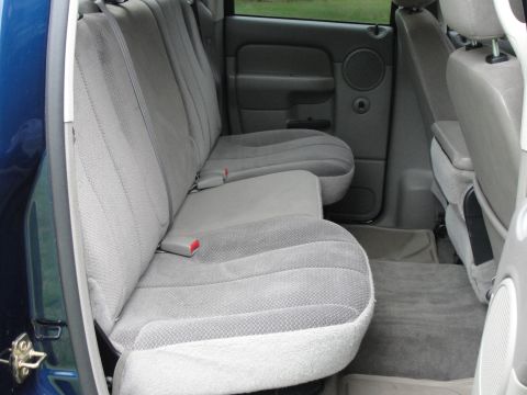 1967 Ford Mustang - Interior view of a pickup truck's rear seating area, gray cloth seats and door trim.