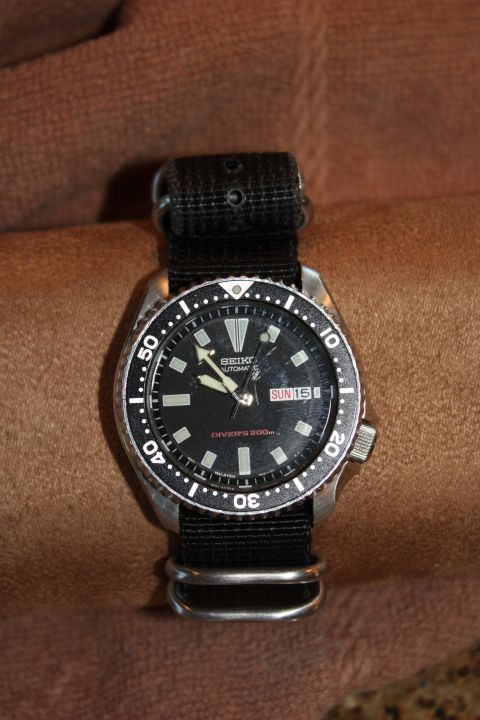 1986 Ford Bronco - A close-up view of a Seiko automatic dive watch with a black dial and bezel.