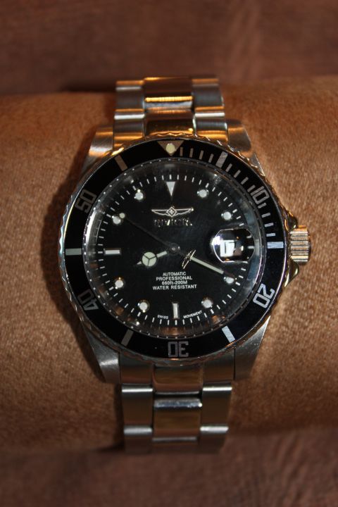 1986 Ford Bronco - Close-up of an Invicta automatic professional water resistant watch with a black dial and rotating bezel.