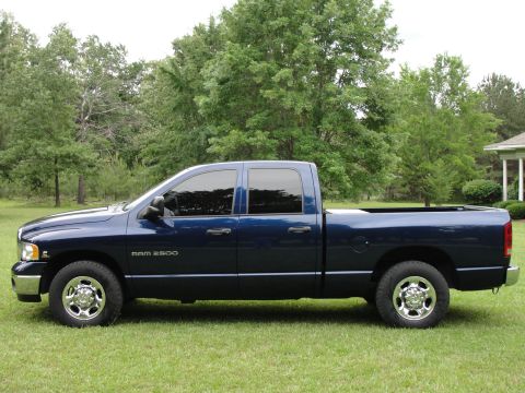 1967 Ford Mustang - This blue Dodge Ram 2500 pickup truck is shown from the side view, parked on a grassy lawn.