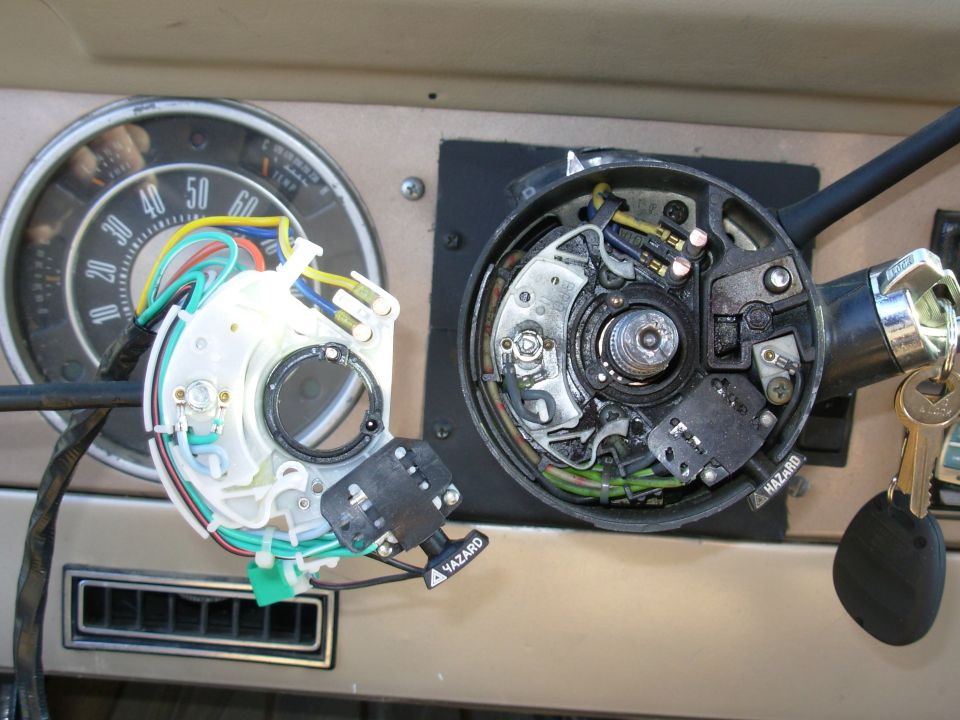 Steering column with removed gauge cluster and exposed turn-signal switch, key in ignition