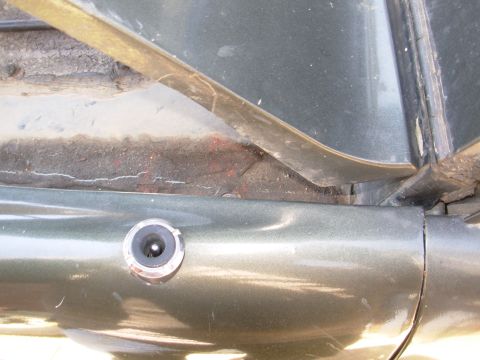 1975 Ford Bronco - The crack in the grime layer of the seam sealer shows that the whole fender shifted back, which is why it's hitting the door.
