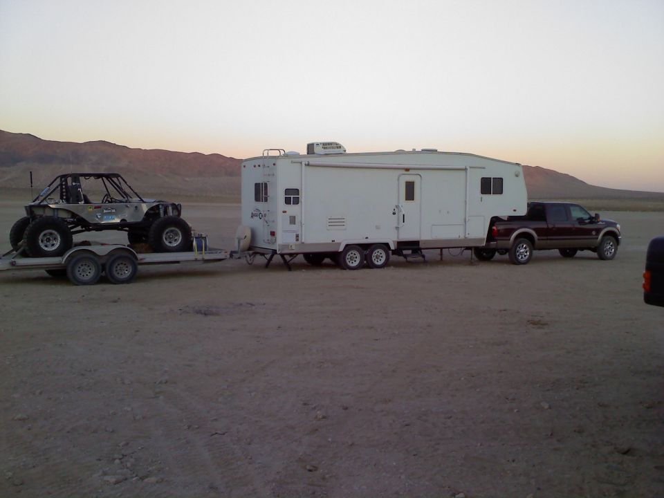 Dark brown 2011 Ford F-250 towing RV and buggy