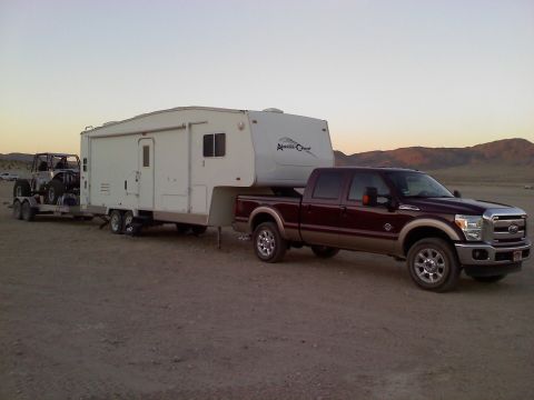 2011 Ford F-250 - 2011 Ford F-250 Super Duty truck is seen towing a fifth-wheel trailer and a UTV on a trailer.