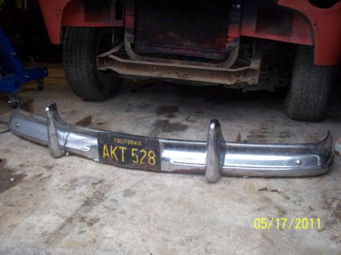 1990 Ford Bronco - Chrome bumper with California license plate AKT 528 is shown in front of a vehicle's wheel and grille.