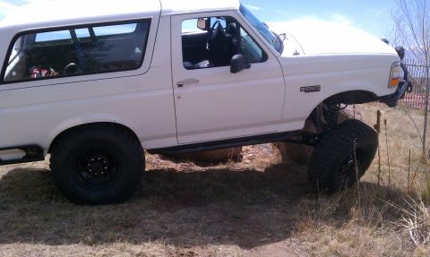 1978 Ford Bronco - This lifted Ford Bronco is navigating a rocky, off-road path.