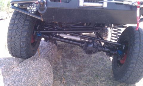 1978 Ford Bronco - Close-up view of the front suspension and undercarriage of an off-road vehicle.