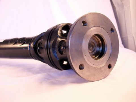 1990 Ford Bronco - A close-up of a vehicle driveshaft component, showing the U-joint and flange connection.