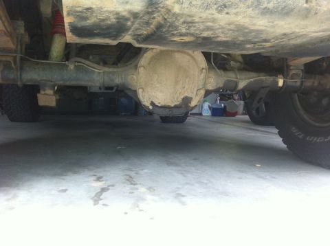 1990 Ford Bronco - Underside view shows the rear axle assembly and suspension parts of a vehicle.