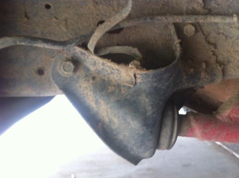 1990 Ford Bronco - This image shows a close-up view of a vehicle's suspension system, with visible dirt and grime.