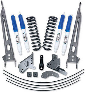 1985 Ford Bronco - A collection of suspension lift kit parts, including shocks, springs, and various metal brackets, laid out against a white background.