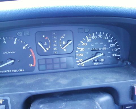 1991 Ford Festiva - The dashboard displays a speedometer, tachometer, fuel, and temperature gauges.