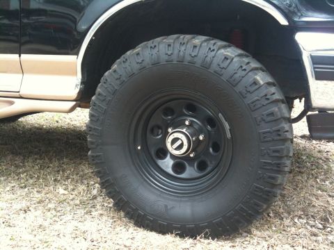 1996 Ford Bronco - Close-up of a 1996 Ford Bronco's wheel and tire assembly, showing off-road tread.