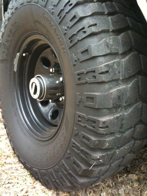 1996 Ford Bronco - A close-up view of a off-road tire and wheel assembly, showing detailed tread patterns.