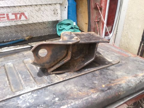 1978 Ford Bronco - A close-up view of a rusted metal bracket resting on a weathered truck bed, with a DELTA logo in the background.