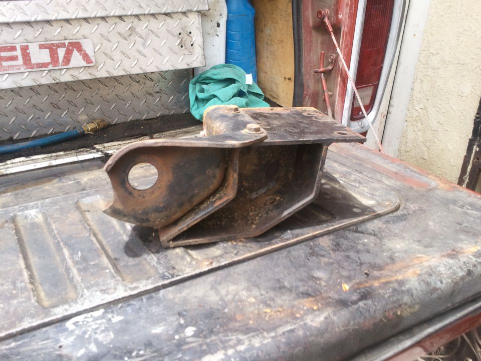 Rusted metal bracket on a truck bed, with DELTA logo visible