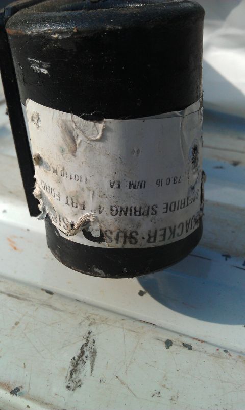 1996 Ford Bronco - Close-up of a shock absorber part with legible text on its label.
