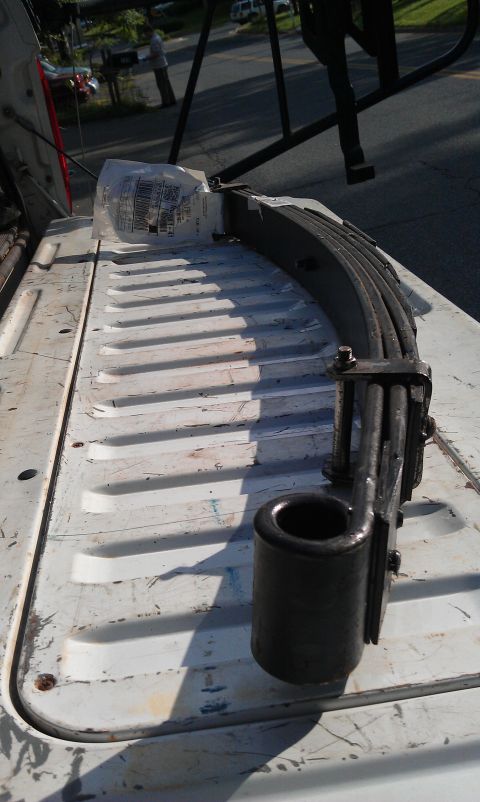 1996 Ford Bronco - A leaf spring assembly is shown in the bed of a truck.