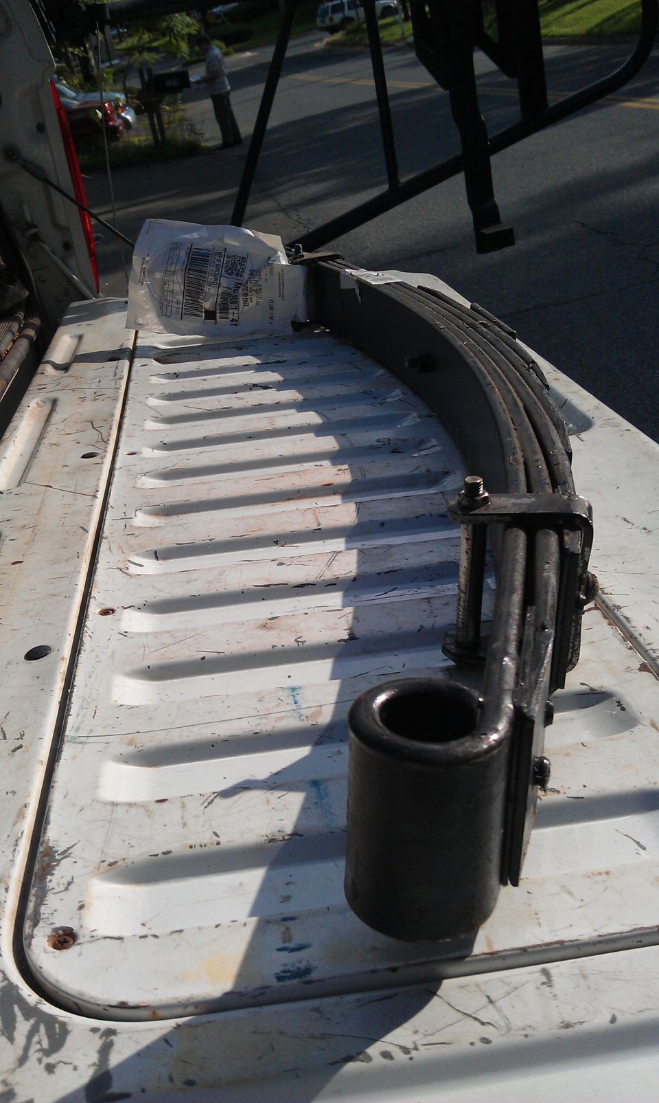 Leaf spring assembly with rubber bushing in a truck bed