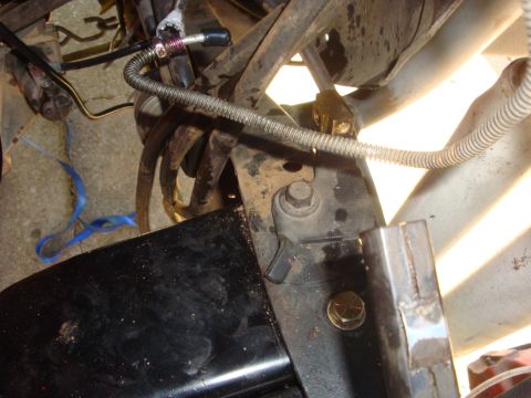 1989 Ford Bronco - Detail shot of vehicle suspension components and brake lines.