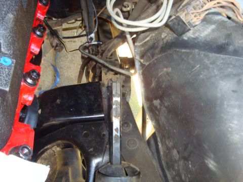 1989 Ford Bronco - Engine bay components visible, including a red bracket and black plastic housing.