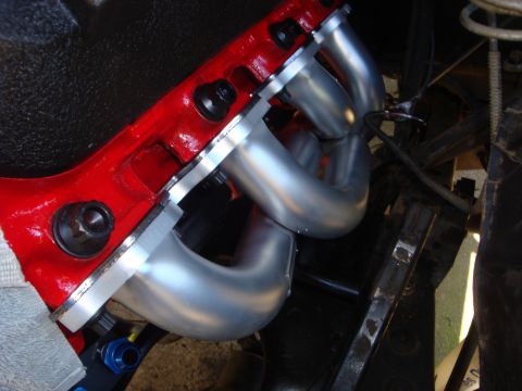 1989 Ford Bronco - A close-up view of an engine's exhaust manifold attached to the cylinder head.