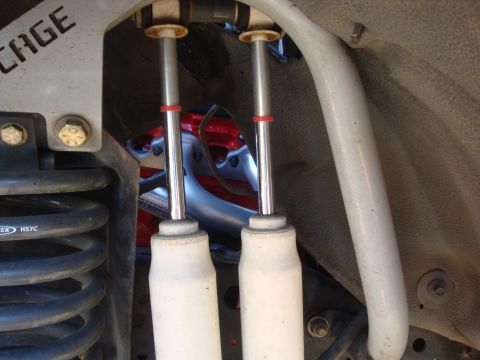 1989 Ford Bronco - Detail shot of suspension and engine parts, with visible text on a coil spring.