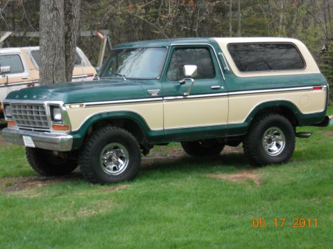 1978 Ford Bronco - A two-tone 1978 Ford Bronco is parked on a grassy lawn next to another vehicle.