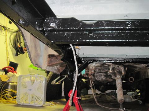 1979 Ford Bronco - Close-up view of the undercarriage and suspension of a vehicle, possibly undergoing restoration.