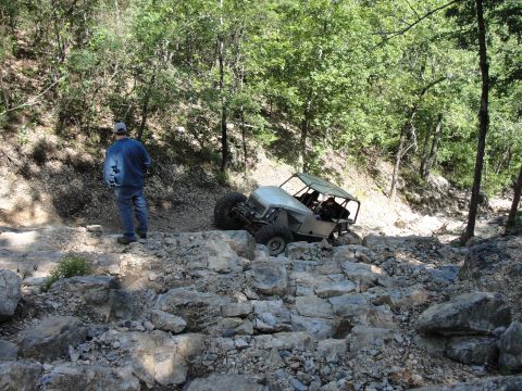 1967 Ford Mustang - Off-road buggy tackling a difficult rocky trail in a wooded area.