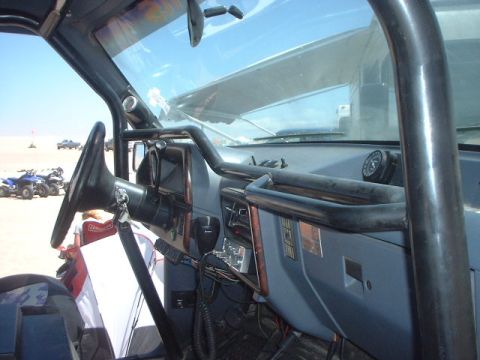 1996 Ford Bronco - Interior view of a 1996 Ford Bronco, modified with a roll cage, showing the dashboard and steering wheel.