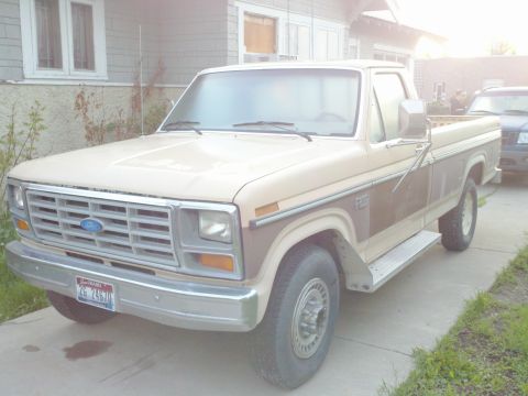1985 Ford F-250 - This Ford pickup truck features a two-tone paint scheme and chrome accents.