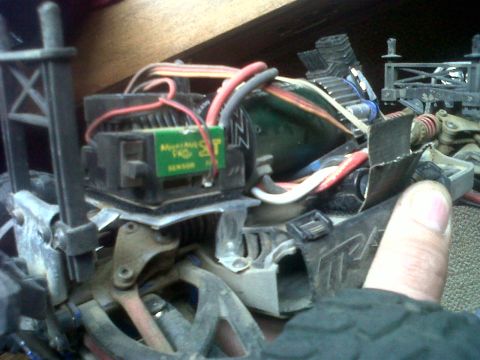 2011 Ford 427 - Close-up of the electronic components and wiring of a remote control car, a circuit board with visible text.