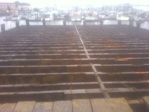 1989 Ford Bronco - View of a harbor with moored boats, seen over weathered dock pilings.