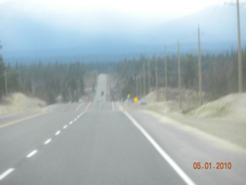 1989 Ford Bronco - A hazy highway scene with distant vehicles and trees lining the roadside, dated 05.01.2010.