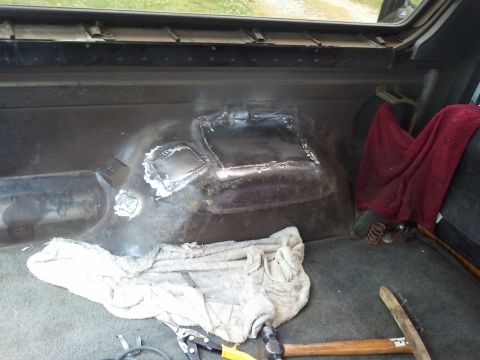 1989 Ford Bronco - Welding repairs are visible on the interior floor of a vehicle, with tools nearby.