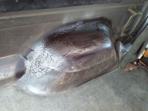 1989 Ford Bronco - Close-up view of the interior floor pan, showing a dark, textured coating.