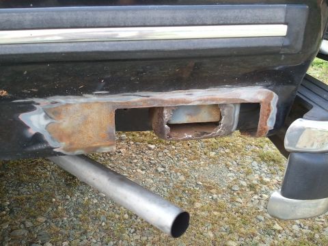 1989 Ford Bronco - The trailer hitch receiver shows significant rust and damage, indicating wear and tear.