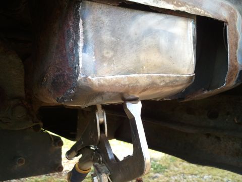 1989 Ford Bronco - Metal repair being performed on the underside of a vehicle frame.